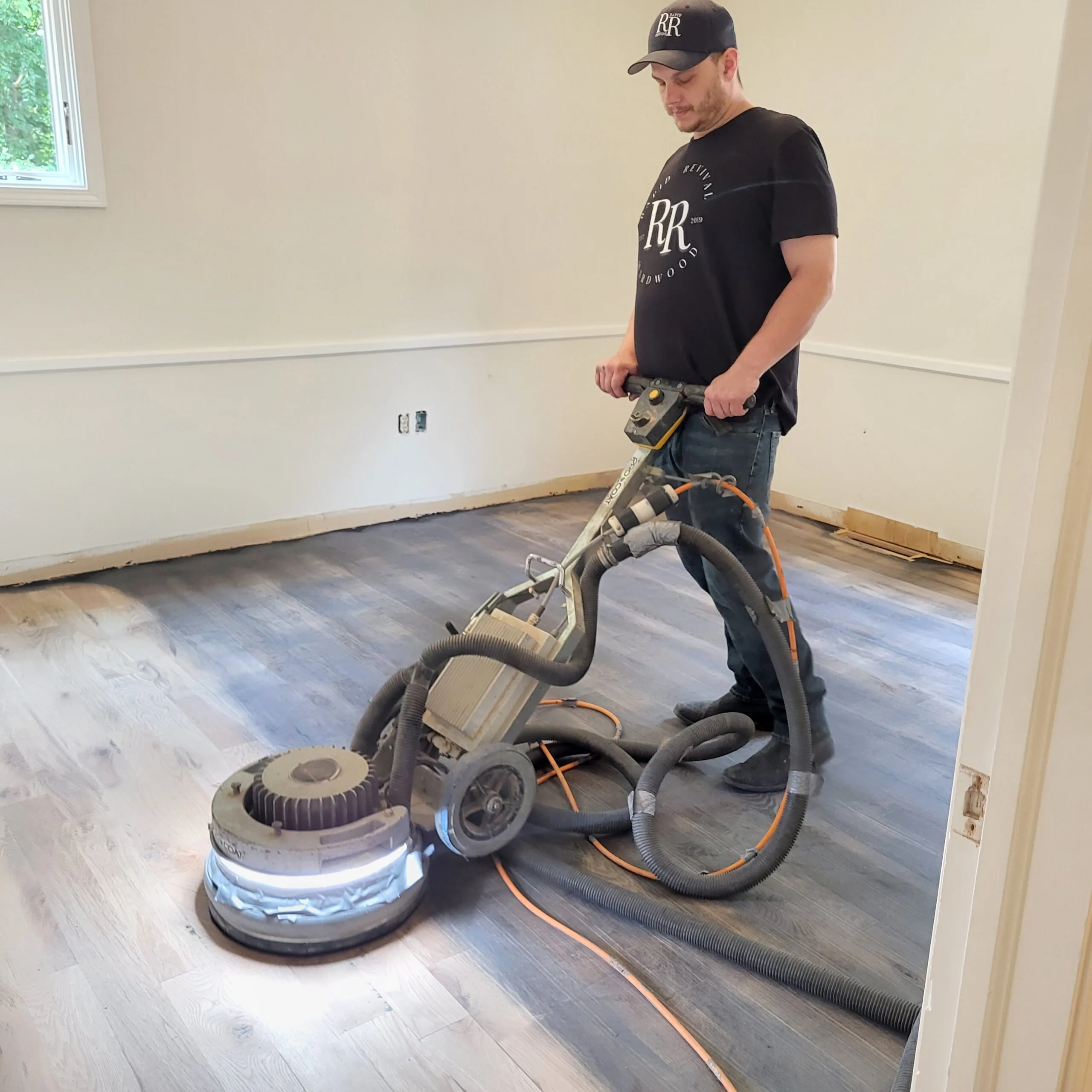 Rapid Revival Hardwood Owner Gage Norris Sanding A Floor Near Waynesville, Mo.