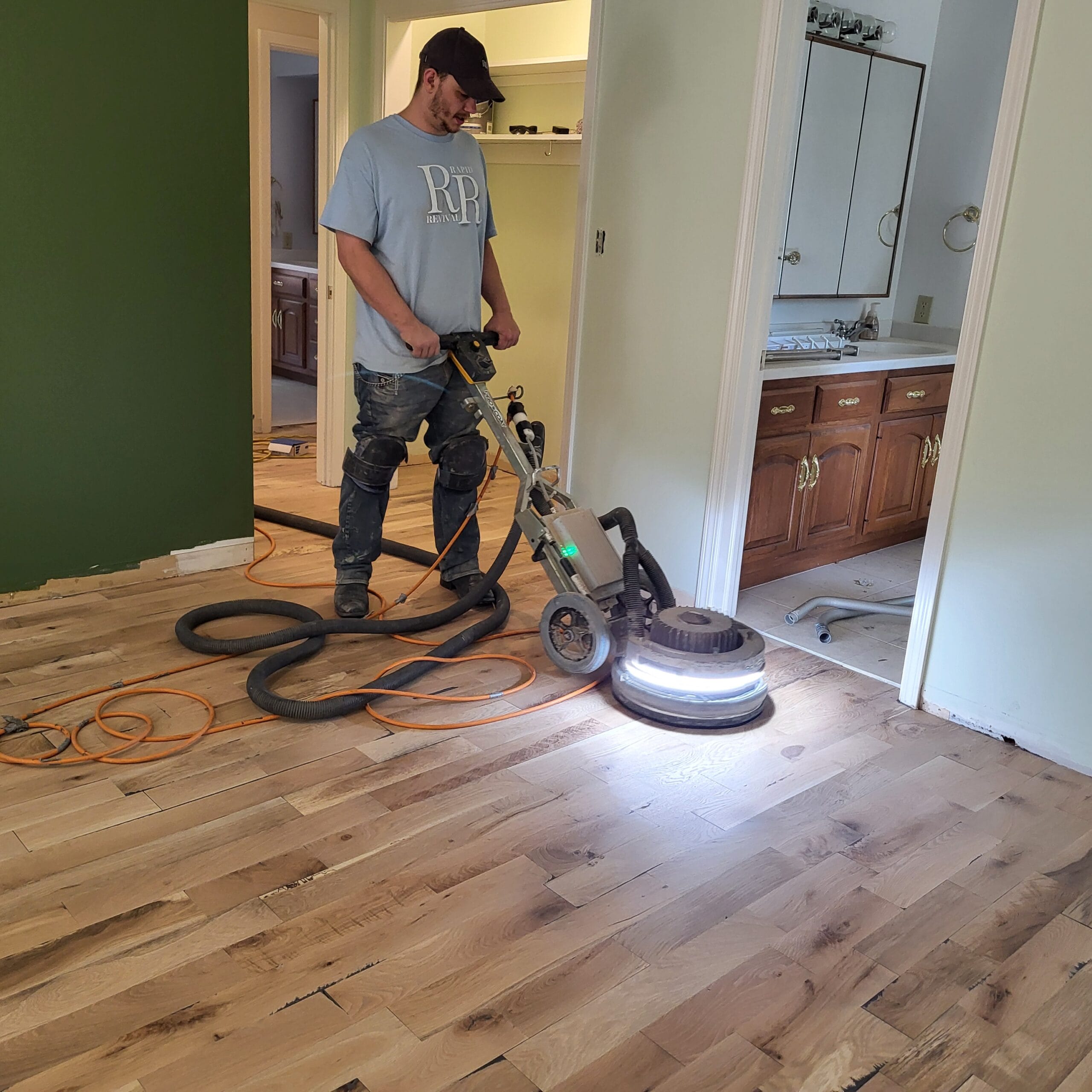 Services Gage Norris Of Rapid Revival Hardwood In Waynesville, Mo, Is Refinishing A Hardwood Floor.