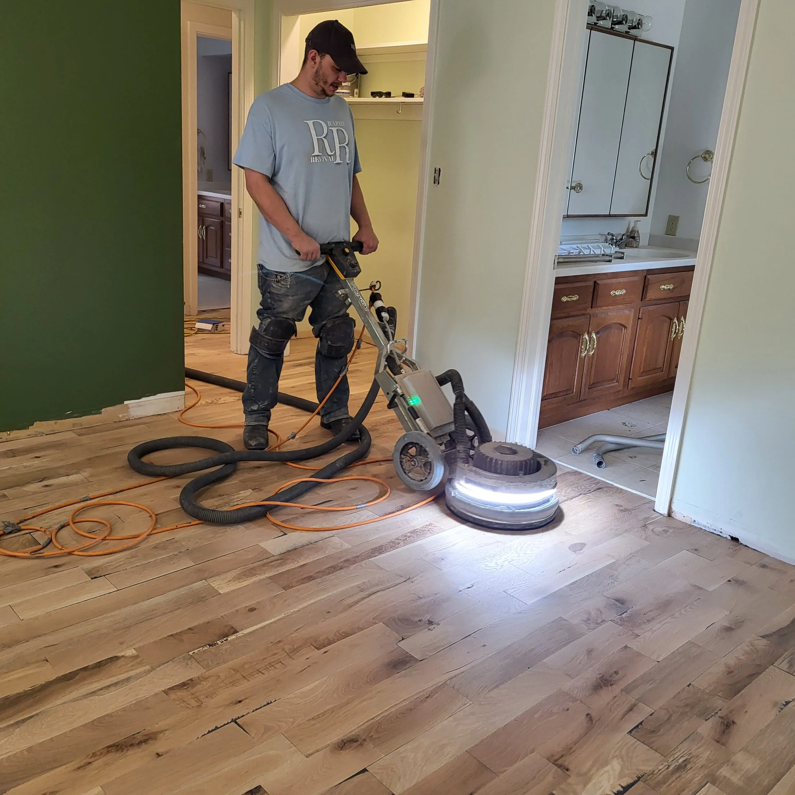 Refinished hardwood flooring with restored color and clean reflection in natural light